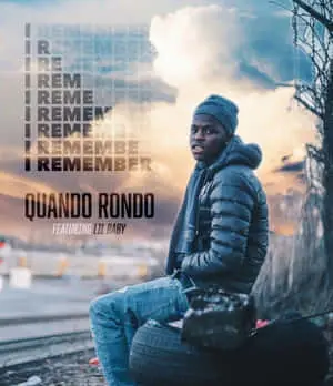  Quando Rondo striking a pose with his stylish outfit and colorful backdrop 